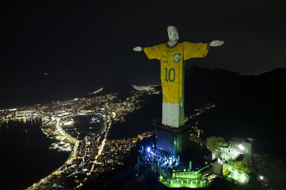 The Christ the Redeemer statue is illuminated with an image of Pele's Brazilian jersey, as a tribute to the soccer legend on his one-year death anniversary, in Rio de Janeiro, Brazil, Friday, Dec. 29, 2023. (AP Photo/Bruna Prado)