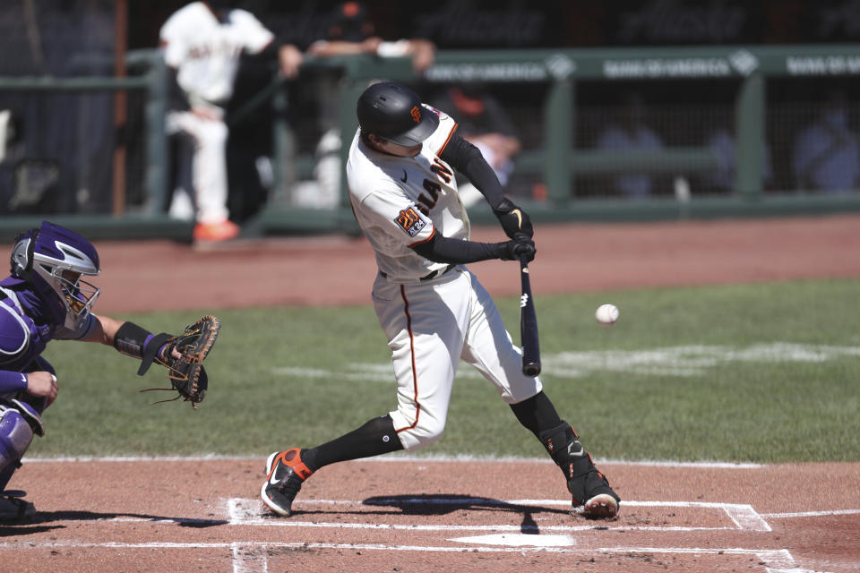 San Francisco Giants' Wilmer Flores hits an RBI single against the Colorado Rockies during the first inning of a baseball game in San Francisco, Thursday, Sept. 24, 2020. (AP Photo/Jed Jacobsohn)