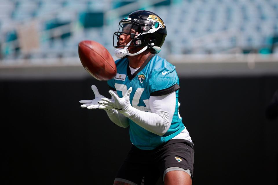 Jacksonville Jaguars running back Snoop Conner (24) fields a pass while participating in an organized team activity Monday, June 6, 2022 at TIAA Bank Field in Jacksonville. 