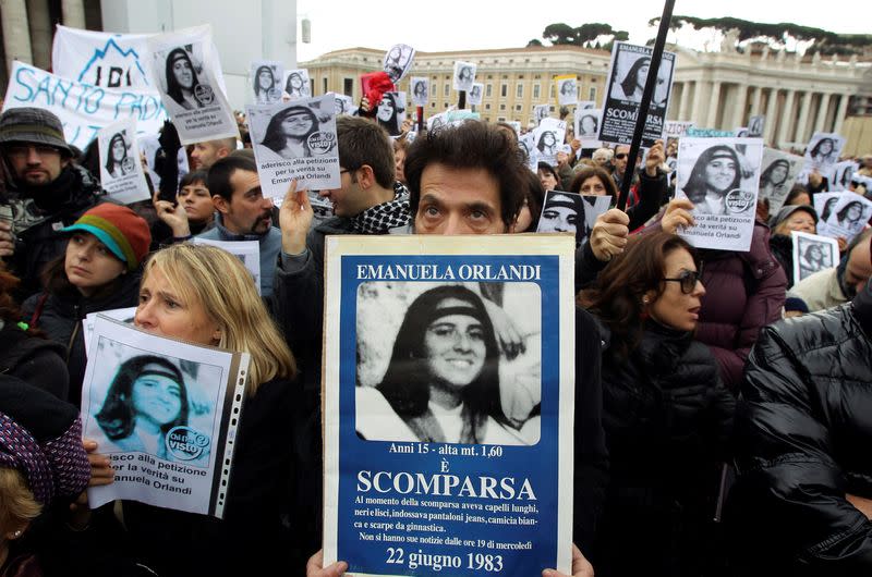 FILE PHOTO: Pietro, brother of Emanuela Orlandi holds a banner with her picture in front of St. Peter square as Pope Benedict XVI leads the angelus prayer