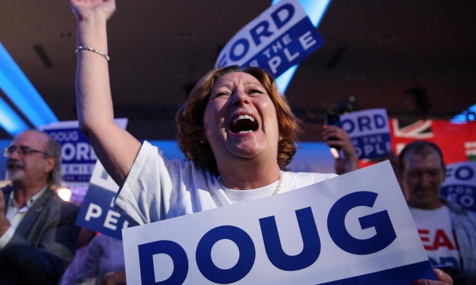 A Doug Ford supporter celebrates the Ontario election results giving a majority to his Progressive Conservative party.