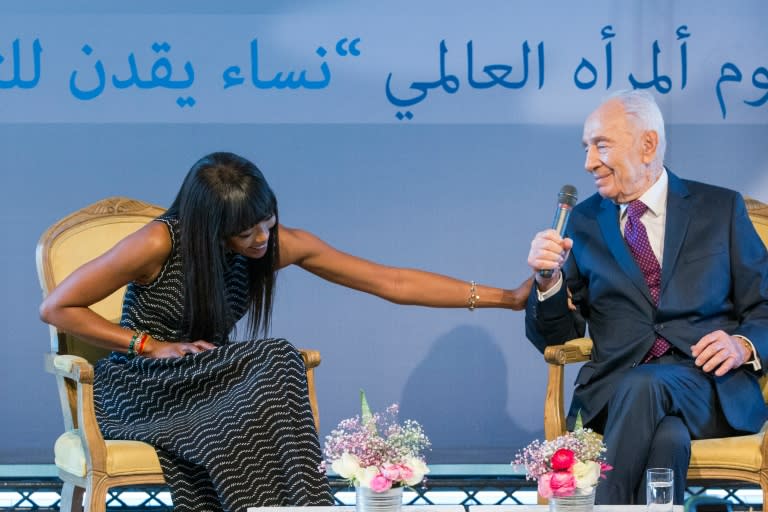 British model Naomi Campbell (L) and former Israeli president Shimon Peres attend an International Women's Day conference at the Peres Center for Peace in Tel Aviv