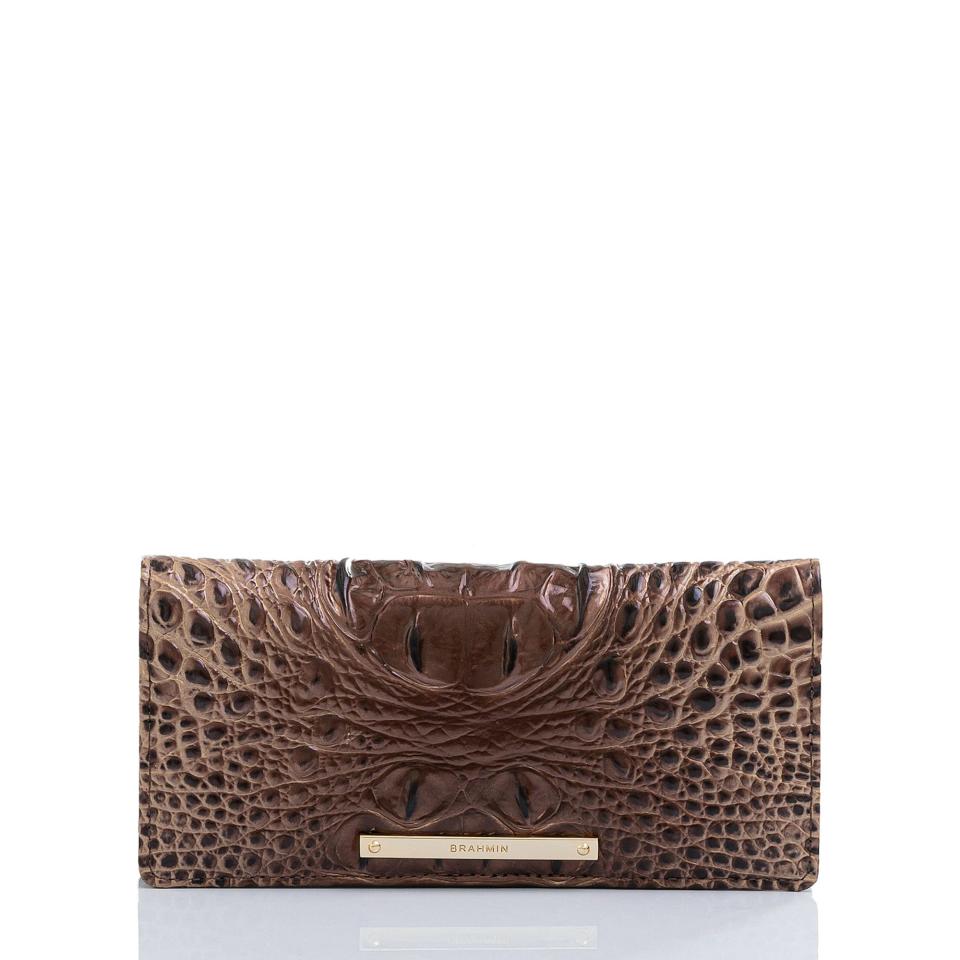 <p><em><strong>Sarah Ball, Market Editor:</strong></em> I always find myself wishing I had a nice wallet, but never seem to buy one for myself, so I'm putting this mocha leather croc-embossed beauty on my list this year. It's thin and offers a ton of convenient storage and the color is so rich looking and will go with everything.</p> <p><strong>Buy it!</strong> Brahmin "Ady" Wallet, $120; <a href="https://www.brahmin.com/ady-wallet-ombre-melbourne/K591708.html?dwvar_K591708_color=Nightfall" rel="nofollow noopener" target="_blank" data-ylk="slk:brahmin.com;elm:context_link;itc:0;sec:content-canvas" class="link ">brahmin.com</a></p>