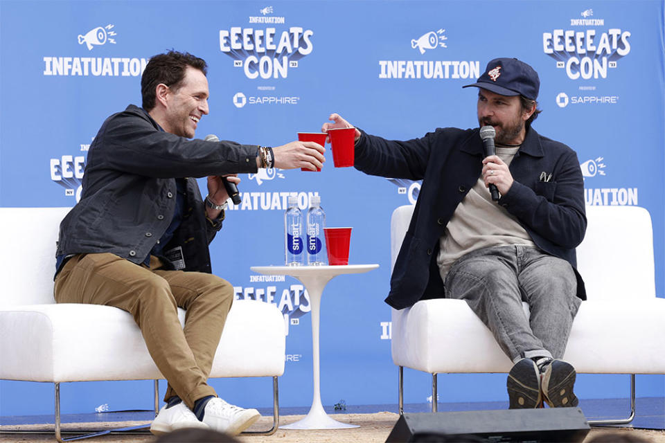 Actors, writers and entrepreneurs Glenn Howerton, left, and Charlie Day of “It’s Always Sunny in Philadelphia” raise a glass of their Four Walls whiskey onstage at The Infatuation's EEEEEATSCON New York presented by Chase Sapphire at Forest Hills Stadium, Sunday, Oct. 8, 2023, in New York.