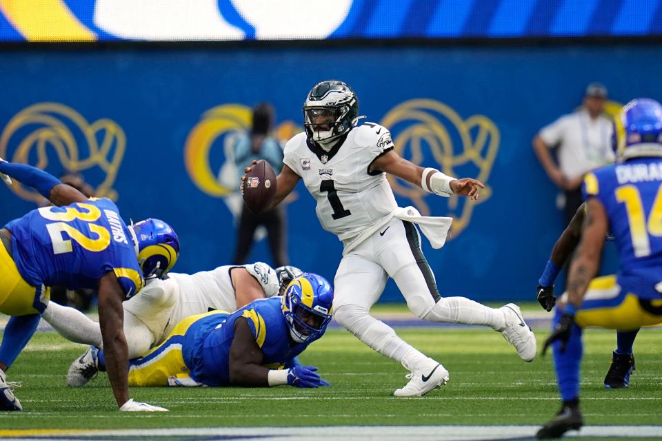 Philadelphia Eagles quarterback Jalen Hurts scrambles with the ball during the first half of an NFL football game against the Los Angeles Rams Sunday, Oct. 8, 2023, in Inglewood, Calif.