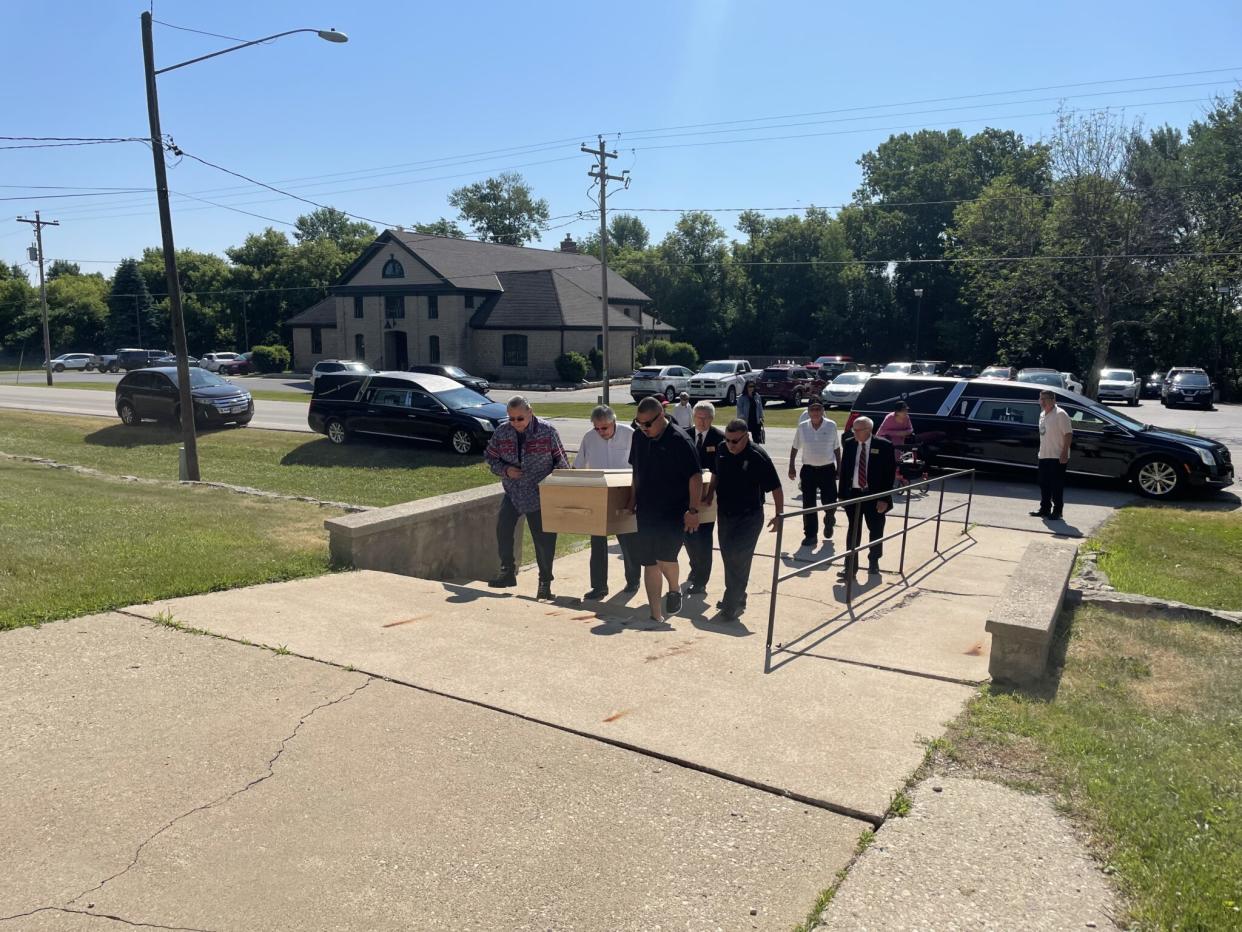 Pallbearers carry the casket of one of the children returned from the cemetery at the Carlisle Indian School in Pennsylvania up the stairs to the Church of the Holy Apostles in Hobart, Wisconsin. Photo by Andrew Kennard