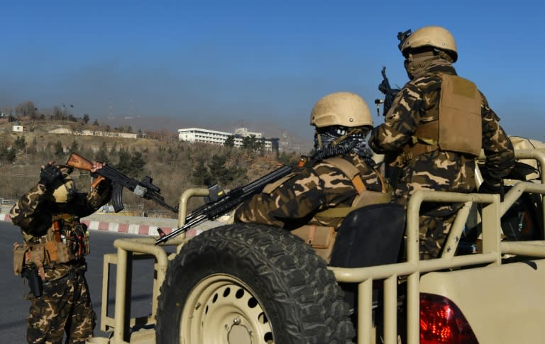 Afghan security personnel stand guard near the Intercontinental Hotel