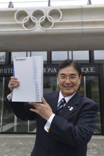 Tokyo 2020 CEO Masato Mizuno poses with the candidature files prior to the handover on January 7, 2013 at the headquarters of the International Olympic Committee in Lausanne