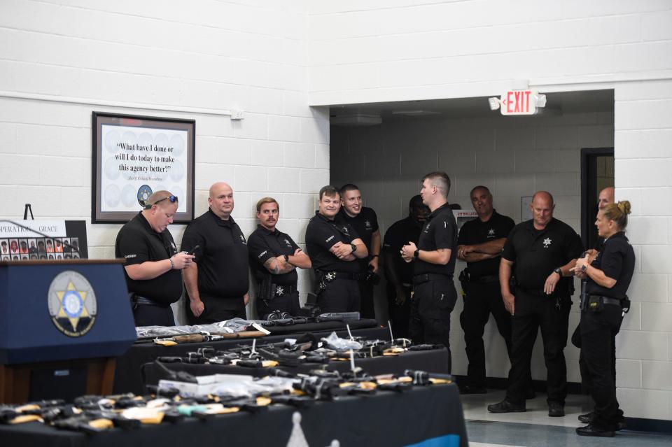 Police officers wait to be briefed on Operation Grace during the Operation Grace press conference at the Richmond County Sheriff's Office South Precinct on Wednesday, Sept. 21, 2022. During Operation Grace, police officers seized 176 guns and large quantities of drugs.