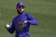 Texas Rangers' Isiah Kiner-Falefa throws during spring training baseball practice Friday, Feb. 26, 2021, in Surprise, Ariz. (AP Photo/Charlie Riedel)