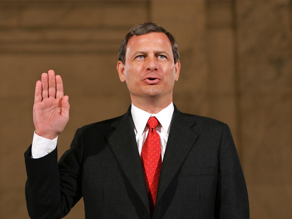 Judge John G. Roberts raises his right hand as he is sworn in before the Senate Judiciary Committe to testify on his confirmation to become the chief justice of the United States on September 12.