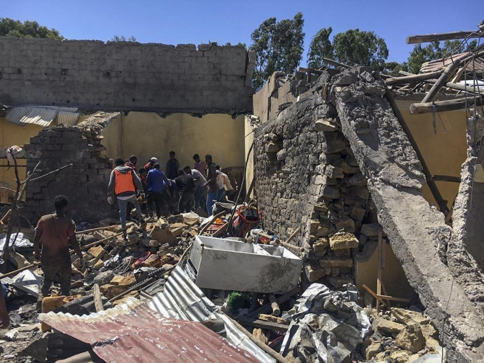 Residents sift through rubble from a destroyed building at the scene of an airstrike in Mekele, in the Tigray region of northern Ethiopia Thursday, Oct. 28, 2021. An Ethiopian government spokesman says a new airstrike has hit Mekele, targeting a site used by rival Tigray forces to make and repair weapons, while a Tigray spokesman instead says it struck a "civilian residence" killing six people and wounding more than 20. (AP Photo)