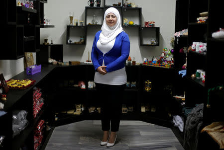 Lara Shahin, 35, a Syrian refugee, poses at a workshop run under Jasmine, a project which hires and trains Syrian refugee women to create handicrafts, in Amman, Jordan, May 16, 2017. REUTERS/Muhammad Hamed