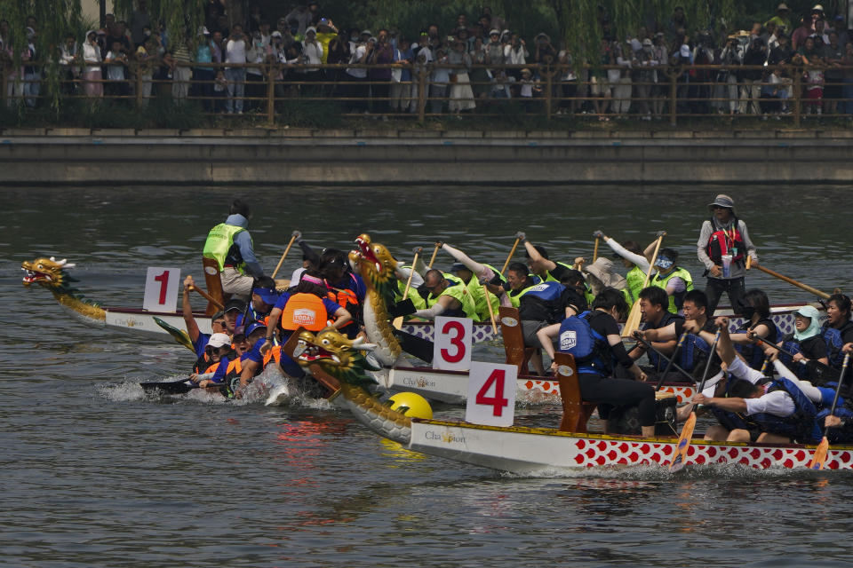 Teams of dragon boat racers crash after one of the boats paddled off direction during the Dragon Boat Festival at a canal in Tongzhou, outskirts of Beijing, Monday, June 10, 2024. The Duanwu Festival, also known as the Dragon Boat Festival, falls on the fifth day of the fifth month of the Chinese lunar calendar and is marked by eating rice dumplings and racing dragon boats. (AP Photo/Andy Wong)