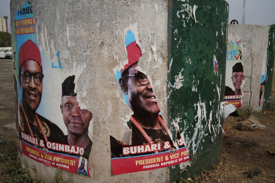 Torn posters of Nigerian Incumbent President Muhammadu Buhari are seen in Abuja Sunday Feb. 24, 2019. Buhari faced opposition presidential candidate Atiku Abubakar in the presidential election. (AP Photo/Jerome Delay)