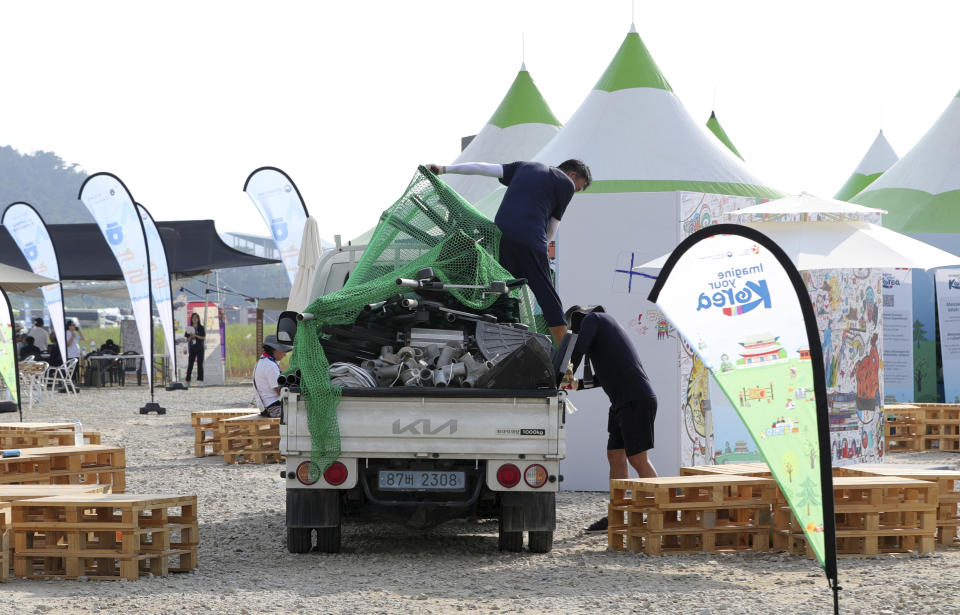 Attendees of the World Scout Jamboree prepare to leave a scout camping site in Buan, South Korea, Monday, Aug. 7, 2023. South Korea will evacuate tens of thousands of scouts by bus from a coastal jamboree site as Tropical Storm Khanun looms, officials said Monday. (Kim-yeol/Newsis via AP)