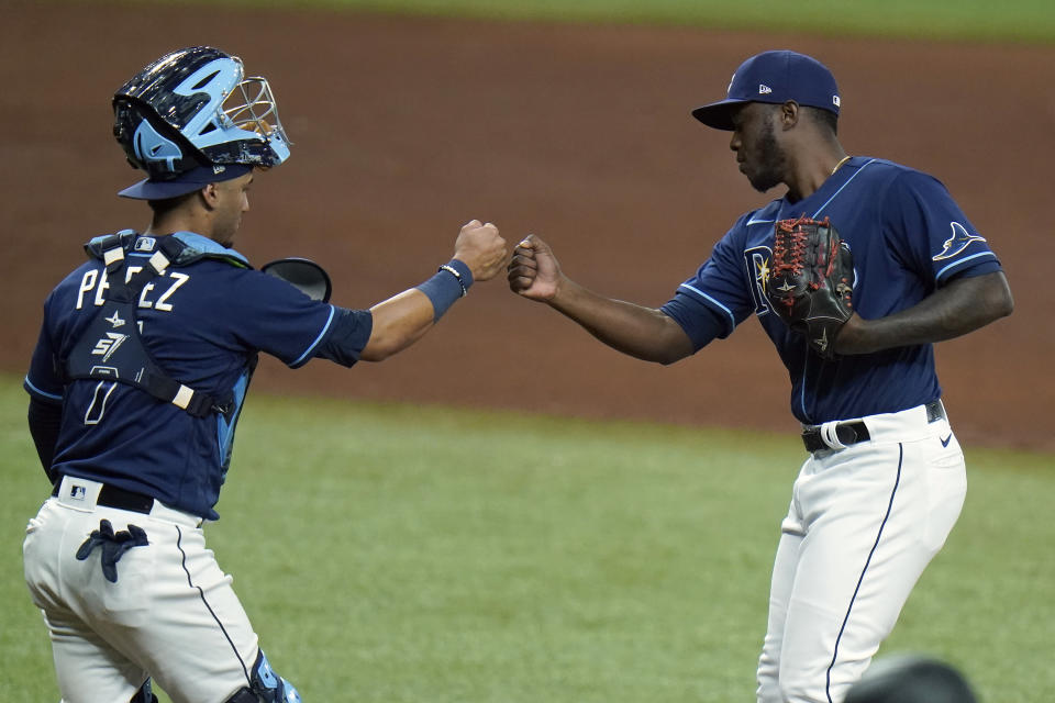 Tampa Bay Rays pitcher Edgar Garcia, right, celebrates with catcher Michael Perez after closing out the Baltimore Orioles during the ninth inning of a baseball game Tuesday, Aug. 25, 2020, in St. Petersburg, Fla. (AP Photo/Chris O'Meara)