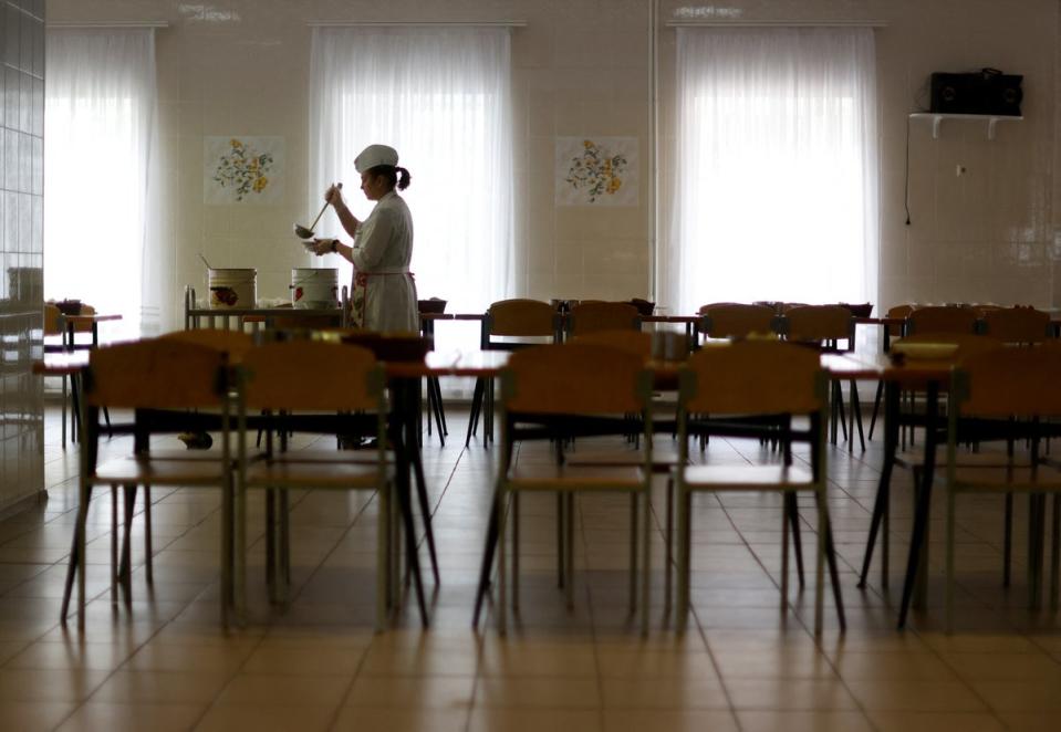 Staff member Oksana Kogat prepares soup in the dining hall (Reuters)