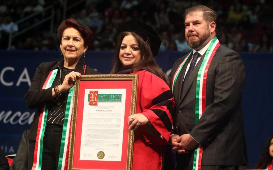 State Sen. Anna Caballero and Assemblymember Joaquín Arámbula presented Visionary Award recipiennt Herminia ‘Minnie’ Santillán with a resolution during the 47th Chicano/Latino Commencement Celebration at the Save Mart Center on May 20, 2023.