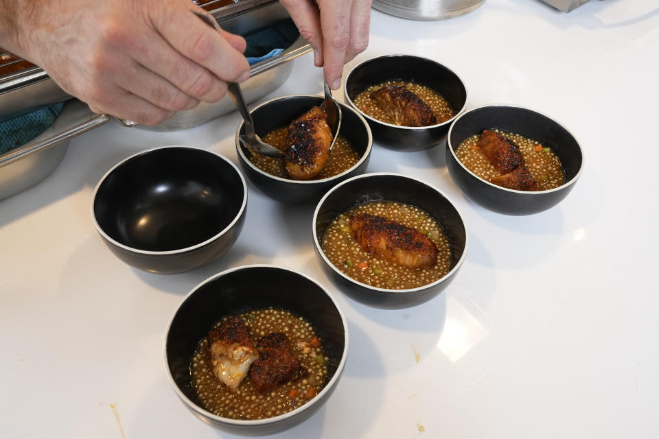 Fish dishes, prepared by 3-star chef Alexandre Mazzia, are presented Tuesday, April 30, 2024 in Paris. Some 40,000 meals will be served each day during the Games to over 15,000 athletes housed at the Olympic village. (AP Photo/Michel Euler)