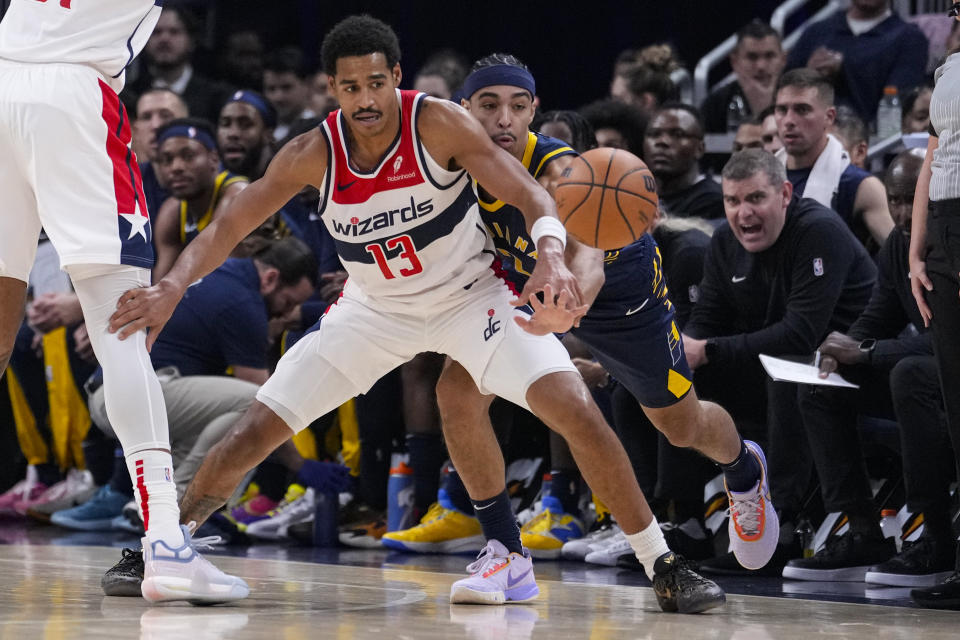 Indiana Pacers guard Andrew Nembhard (2) knocks the ball away from Washington Wizards guard Jordan Poole (13) during the first half of an NBA basketball game in Indianapolis, Wednesday, Oct. 25, 2023. (AP Photo/Michael Conroy)