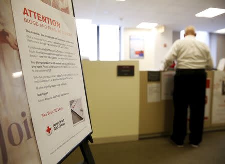 A blood donor (R) checks in at the American Red Cross Charles Drew Donation Center in Washington February 16, 2016. REUTERS/Gary Cameron