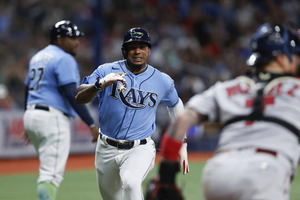 Tampa Bay Rays' Wander Franco runs past Boston Red Sox catcher Christian Vazquez (7) to score during the fifth inning of a baseball game, Sunday, Aug. 1, 2021, in St. Petersburg, Fla. (AP Photo/Scott Audette)