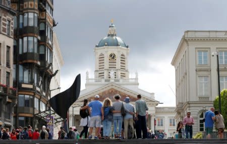 Tourists pose for a photograph near Grand Place in Brussels, Belgium, August 3, 2017. REUTERS/Francois Lenoir