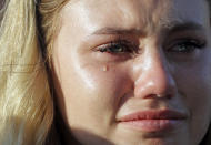 <p>A tear rolls down the face of Sante Fe High School junior Paige Keenan during a prayer vigil following a shooting at Santa Fe High School in Santa Fe, Texas, on Friday, May 18, 2018. (Photo: David J. Phillip/AP) </p>