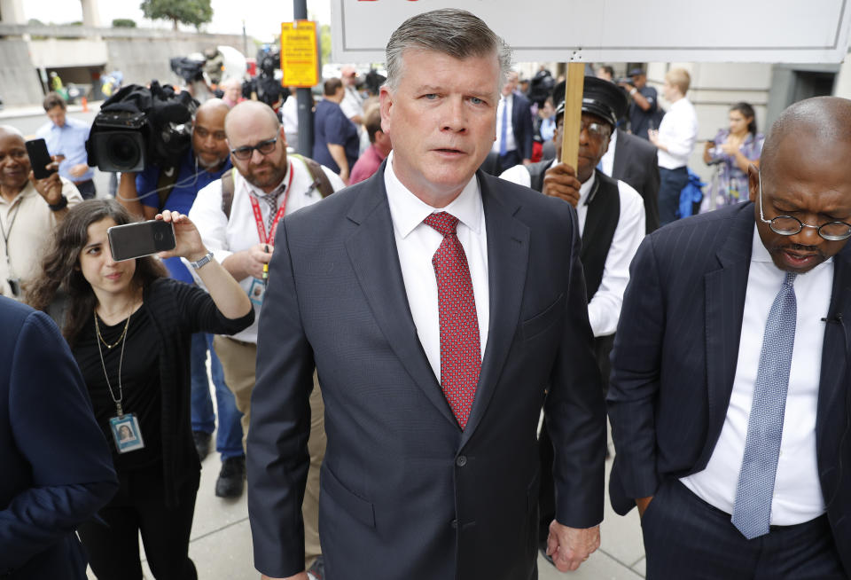 Members of the media follow attorney Kevin Downing, center, with the defense team for Paul Manafort, leaving federal court in Washington, Friday, Sept. 14, 2018. Former Trump campaign chairman Paul Manafort has pleaded guilty to two federal charges as part of a cooperation deal with prosecutors. The deal requires him to cooperate "fully and truthfully" with special counsel Robert Mueller's Russia investigation. The charges against Manafort are related to his Ukrainian consulting work, not Russian interference in the 2016 presidential election.(AP Photo/Pablo Martinez Monsivais)