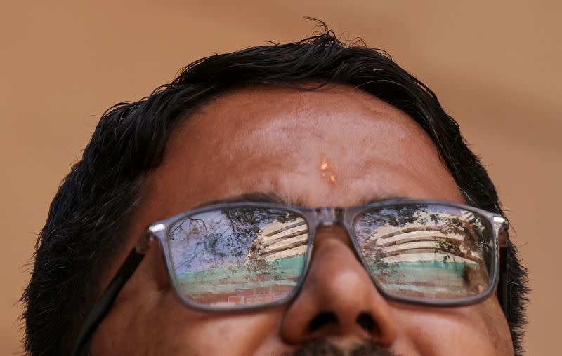 A man watches results for India's general elections on a screen outside the Bombay Stock Exchange (BSE) in Mumbai