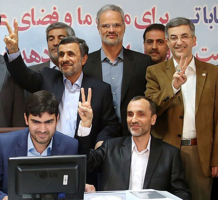 Ex-Iranian President Mahmoud Ahmadinejad (2nd row, L) gestures as he submits his name for registration as a candidate in Iran's presidential election, in Tehran, Iran April 12, 2017. Tasnim News Agency/Handout via REUTERS