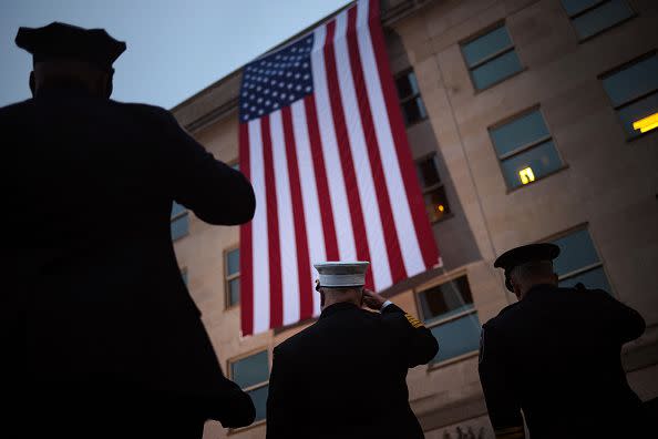 ARLINGTON, VIRGINIA - SEPTEMBER 11: First responders watch as an American flag is unfurled during a ceremony observing the 9/11 terrorist attacks at the Pentagon on September 11, 2023 in Arlington, Virginia. The Defense Department held a remembrance ceremony for the 184 lives lost in the 2001 terrorist attack on the Pentagon. Today marks the 22nd anniversary of September 11, 2001 terrorist attacks at the World Trade Center, the Pentagon and Shanksville, Pennsylvania. (Photo by Win McNamee/Getty Images)