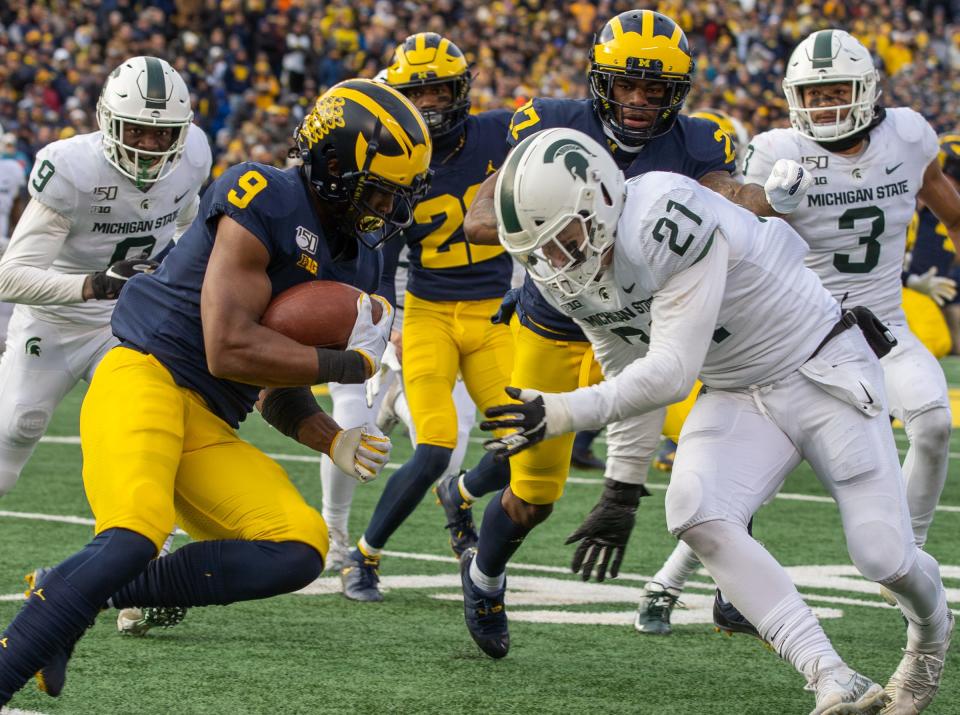 Michigan receiver Donovan Peoples-Jones carries the ball before being tackled by Michigan State linebacker Chase Kline at Michigan Stadium in Ann Arbor, Saturday, Nov. 16, 2019. Michigan won, 44-10.