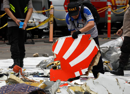 Rescue workers load up recovered debris of Lion Air flight JT610 onto a truck at Tanjung Priok port in Jakarta, Indonesia, November 2, 2018. REUTERS/Edgar Su