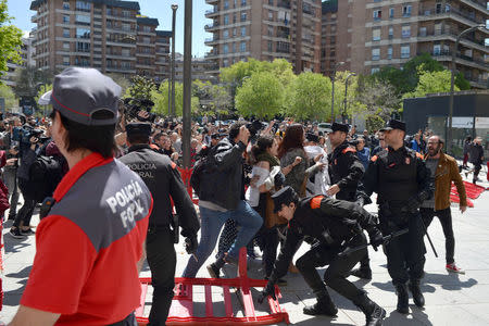 Protesters break through a police line after a nine-year sentence was given to five men accused of the multiple rape of a woman during Pamplona's San Fermin festival in 2016, in Pamplona, Spain, April 26, 2018. REUTERS/Vincent West