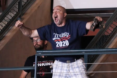 Trump supporter Dawson cheers after helping to eject a small group of protesters during a Trump campaign rally in Manchester, New Hampshire