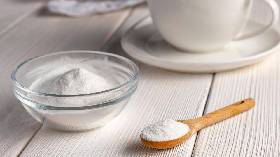 Bowl of allulose sweetener, which speeds weight loss, next to a cup of coffee