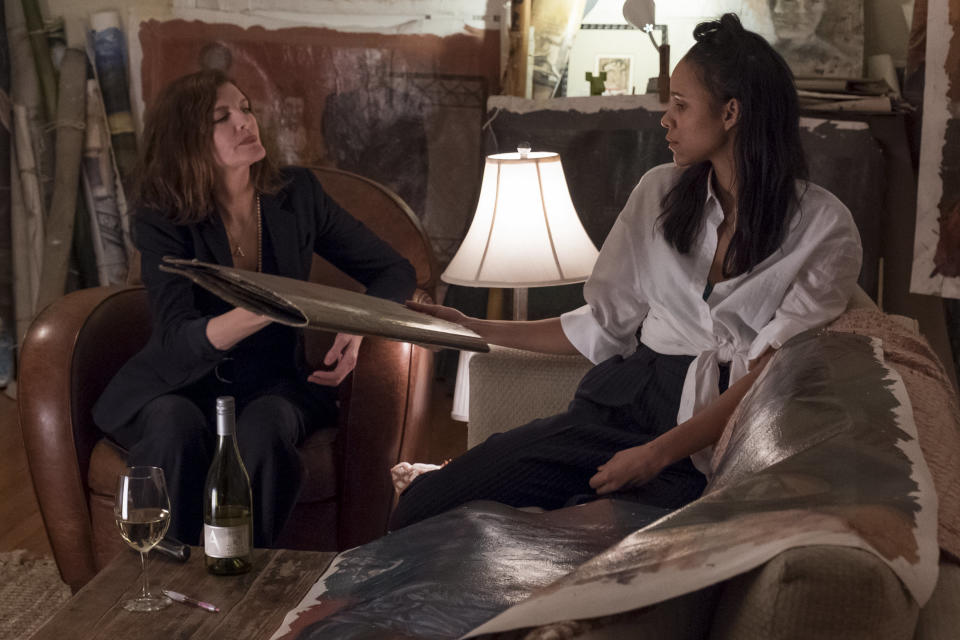 Rhodora and Josephina looking through Vetril Dease's paintings, not realizing they're haunted. (Photo: Netflix )