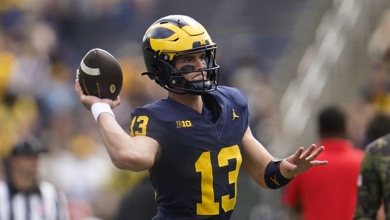 Michigan quarterback Jack Tuttle (13) throws before an NCAA college football game against UNLV in Ann Arbor, Mich., Saturday, Sept. 9, 2023. 