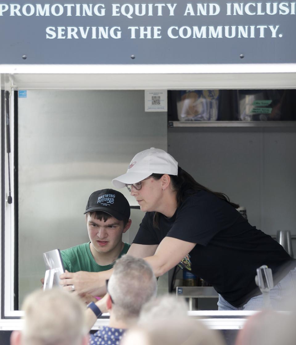 Devin Sullivan and Oshkosh North Special Education Teacher Amanda Powers take orders Tuesday, following the ribbon cutting ceremony for the Brewing Futures Mobile CAFE at the Oshkosh Area School District's administration office parking lot.