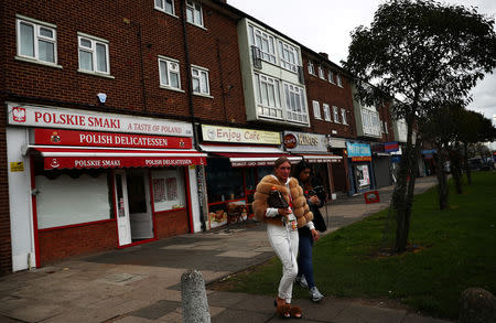 Women walk near a Polish shop in Dagenham, east London, Britain, March 19, 2019. REUTERS/Hannah McKay