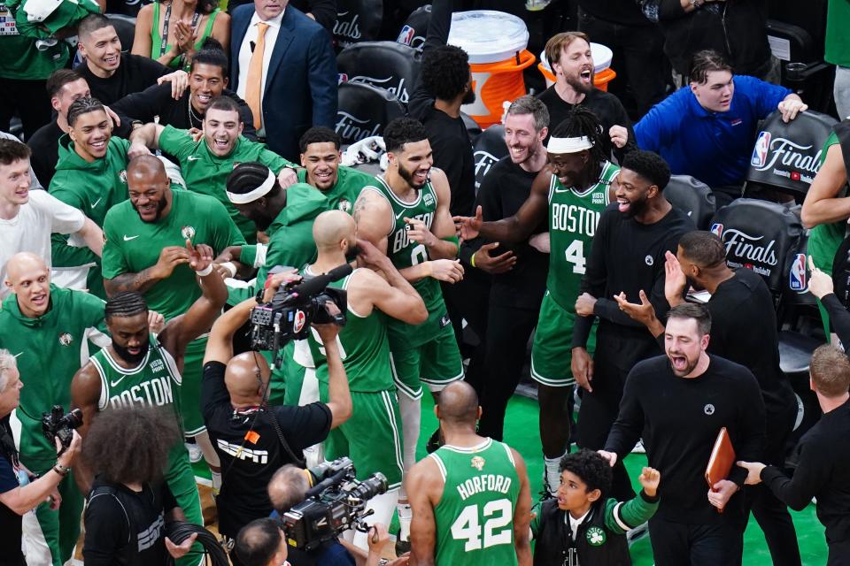 Boston Celtics forward Jayson Tatum (0) celebrates with teammates after defeating the Dallas Mavericks in Game 5 to win the franchise's 18th NBA title.