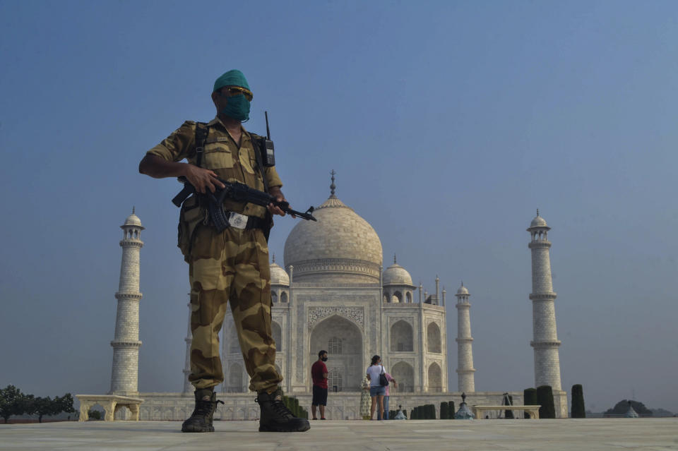 A paramilitary soldier wearing a mask stands guard as the Taj Mahal monument is reopened after being closed for more than six months due to the coronavirus pandemic in Agra, India, Monday, Sept.21, 2020. (AP Photo/Pawan Sharma)