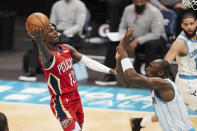 New Orleans Pelicans guard Kira Lewis Jr. (13) looks to shoot over Charlotte Hornets center Bismark Biyombo during the first half of an NBA basketball game Sunday, May 9, 2021, in Charlotte, N.C. (AP Photo/Brian Westerholt)