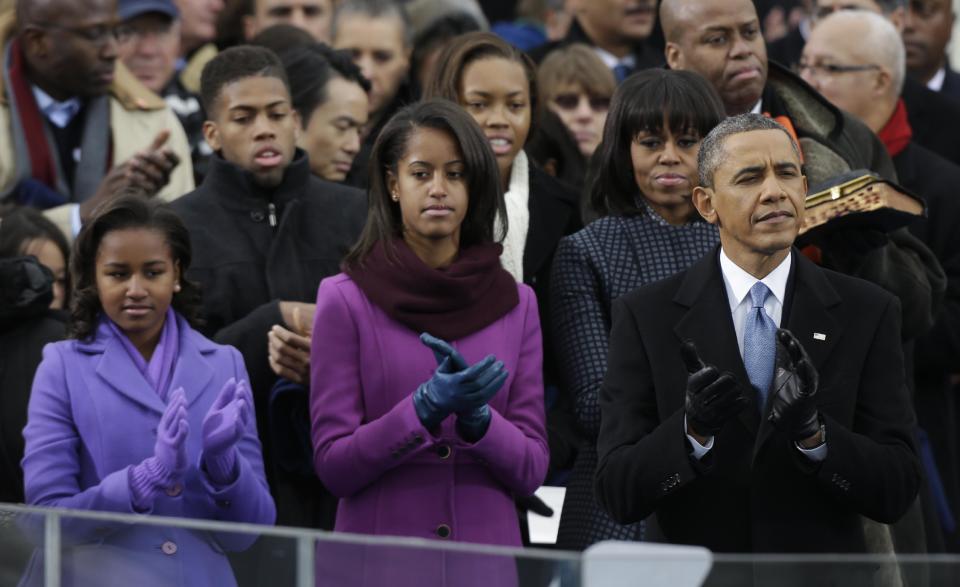 President Barack Obama applauds with his wife Michelle and daughters Sasha and Malia before his ceremonial swearing-in at the U.S. Capitol during the 57th Presidential Inauguration in Washington, Monday, Jan. 21, 2013. (AP Photo/Pablo Martinez Monsivais)