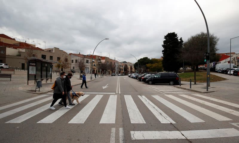 Hector Aguera, who is diagnosed with autism, and his assistant dog Niko go for a walk with his mother Manoli Perez in Terrassa