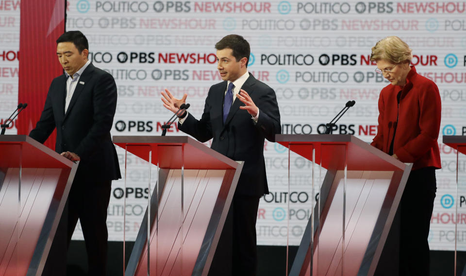 Democratic presidential candidate South Bend Mayor Pete Buttigieg, center, speaks beside entrepreneur Andrew Yang, left, and Sen. Elizabeth Warren, D-Mass., during a Democratic presidential primary debate Thursday, Dec. 19, 2019, in Los Angeles. (AP Photo/Chris Carlson)