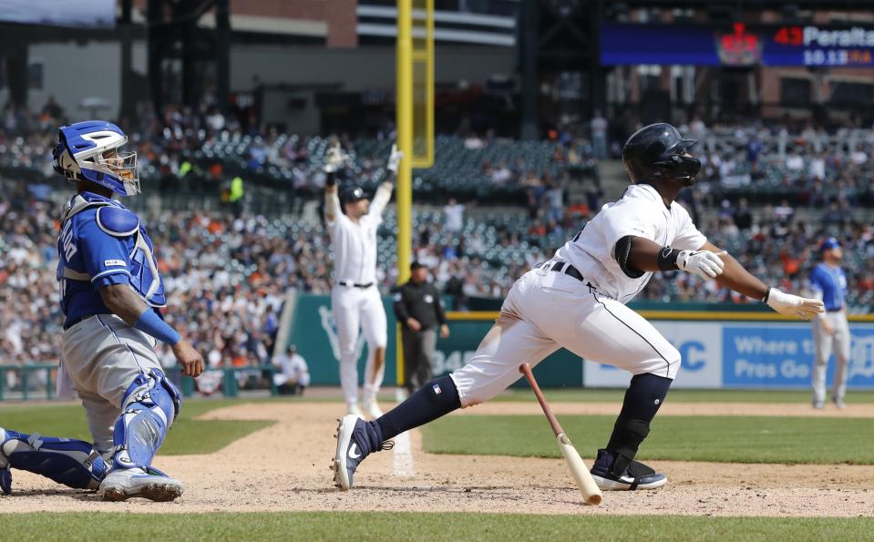 Detroit Tigers' Christin Stewart watches his grand slam clear the outfield wall during the seventh inning of a baseball game against the Kansas City Royals, Saturday, April 6, 2019, in Detroit. In the background is Detroit Tigers' Nicholas Castellanos raising his arms in celebration. (AP Photo/Carlos Osorio)