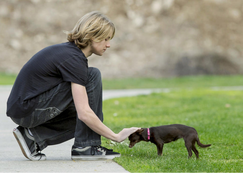 In this Nov. 16, 2012, photo, Lou Wegner, the founder of Kids Against Animal Cruelty, poses for a photo in Burbank, Calif., with his dog Pearl, who was rescued from a shelter. Lou, a 16-year-old actor and singer from Columbus, Ohio, started Kids Against Animal Cruelty when he was 14. The organization, which uses social networking to encourage adoptions at high-kill animal shelters, has helped 20,000 pets escape euthanasia in two years. (AP Photo/Damian Dovarganes)